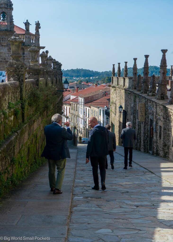 Spain, Santiago, Men Walking on Historic Street